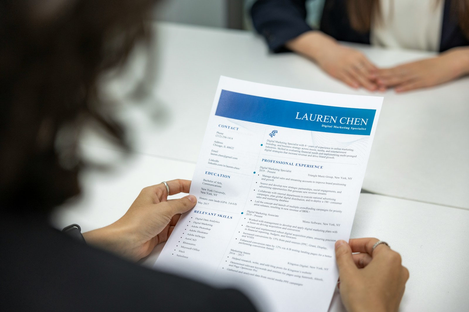 A close-up view of a resume and CV paper being reviewed during a job interview.